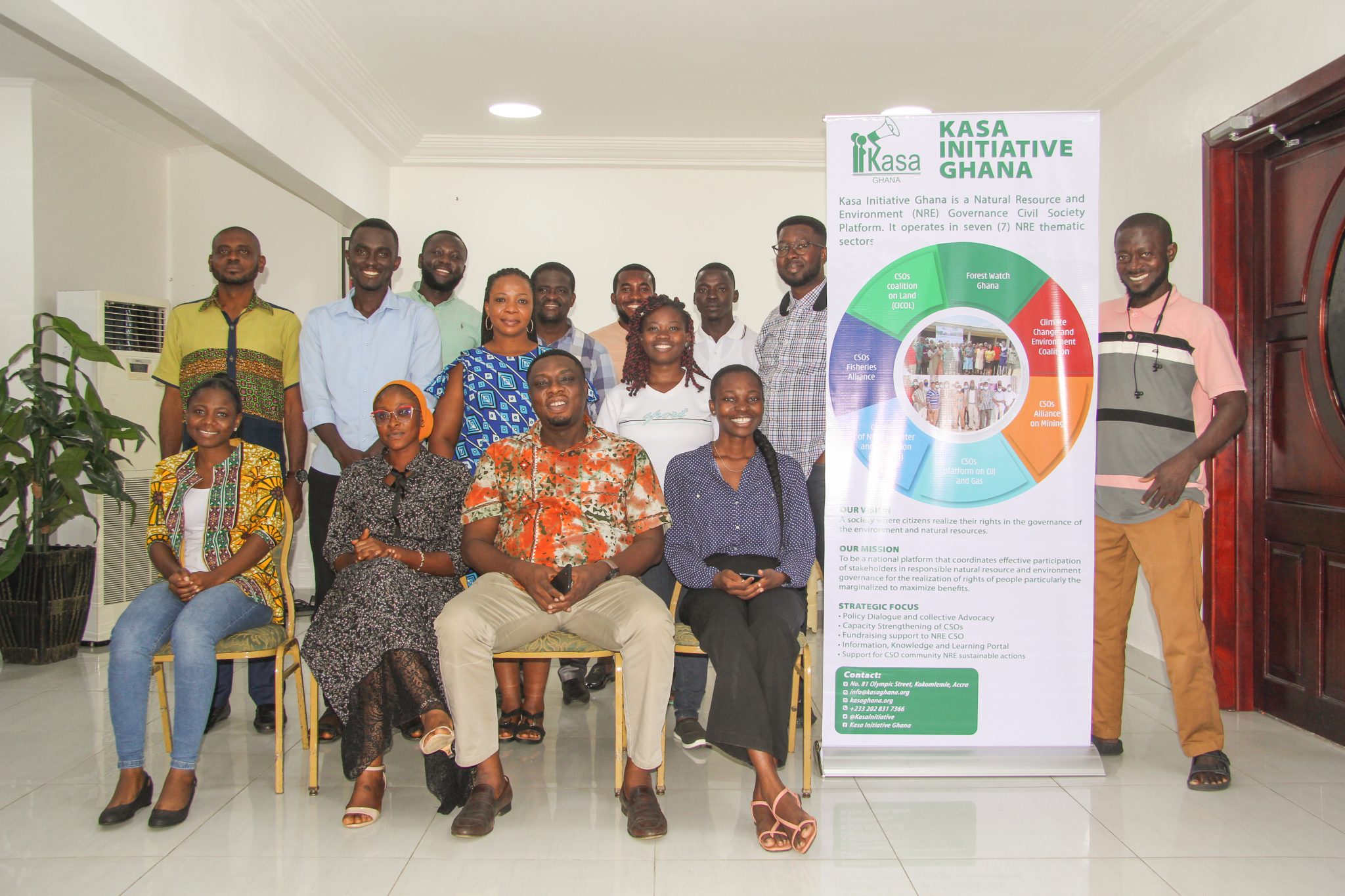 Group photograph of participants beside a Kasa Initiative Ghana banner at the Capacity Enhancement Workshop